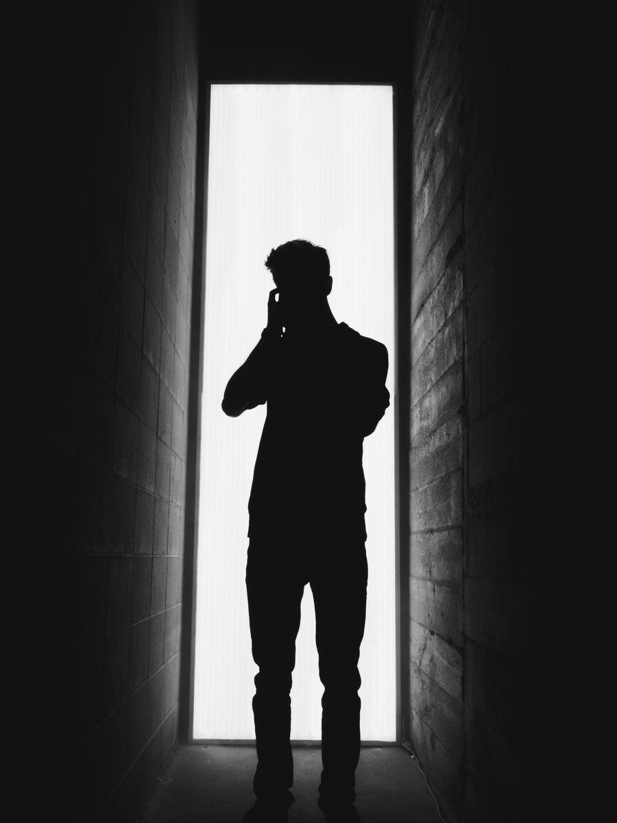 A figure in the light, on the phone