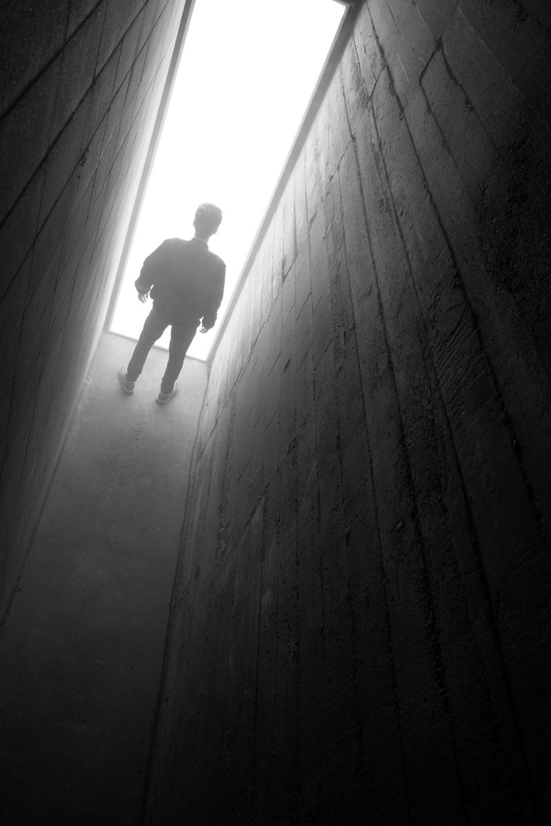 A visitor in the light at the end of the alley